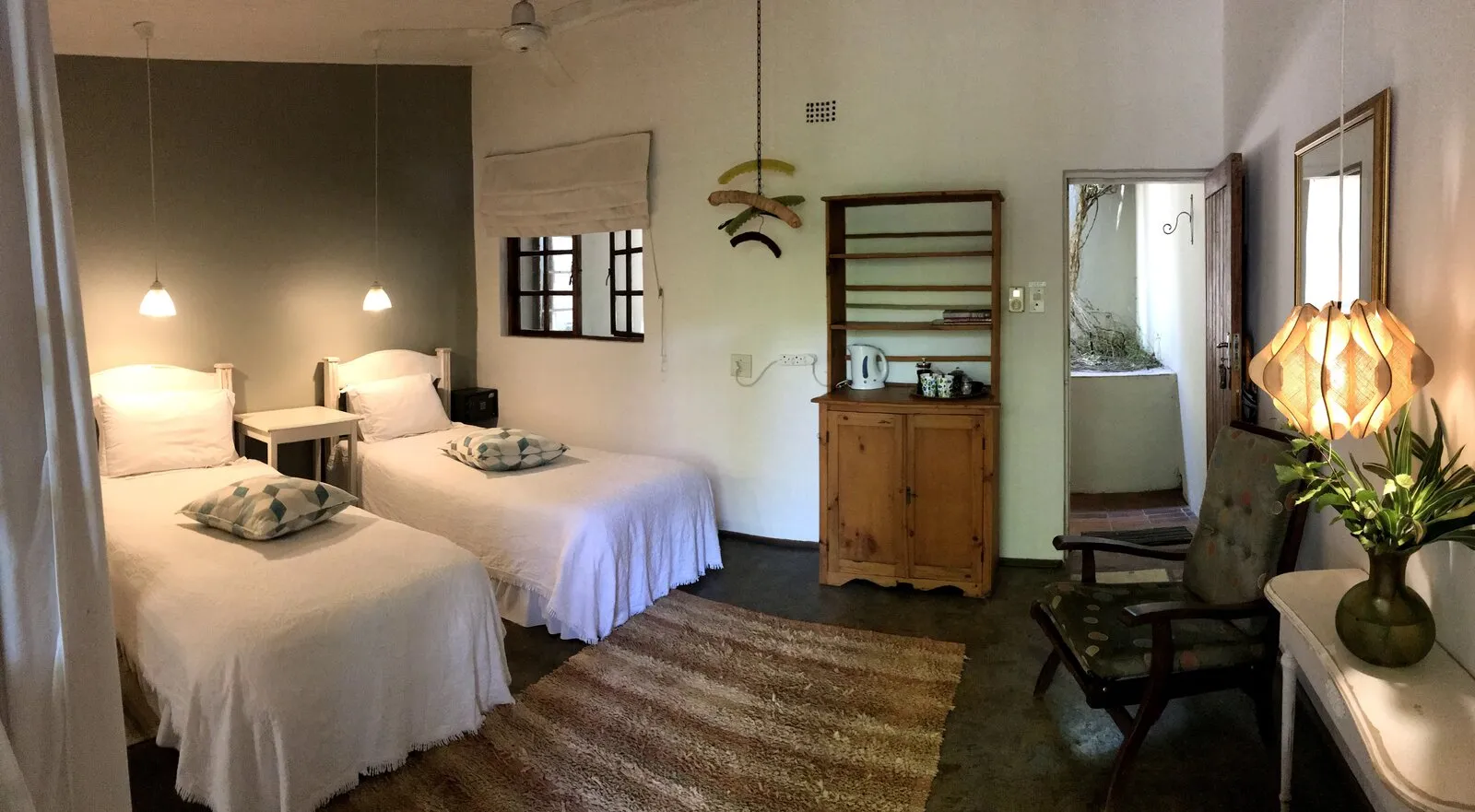 Twin-bed kaia room with pendant lights and warm textures